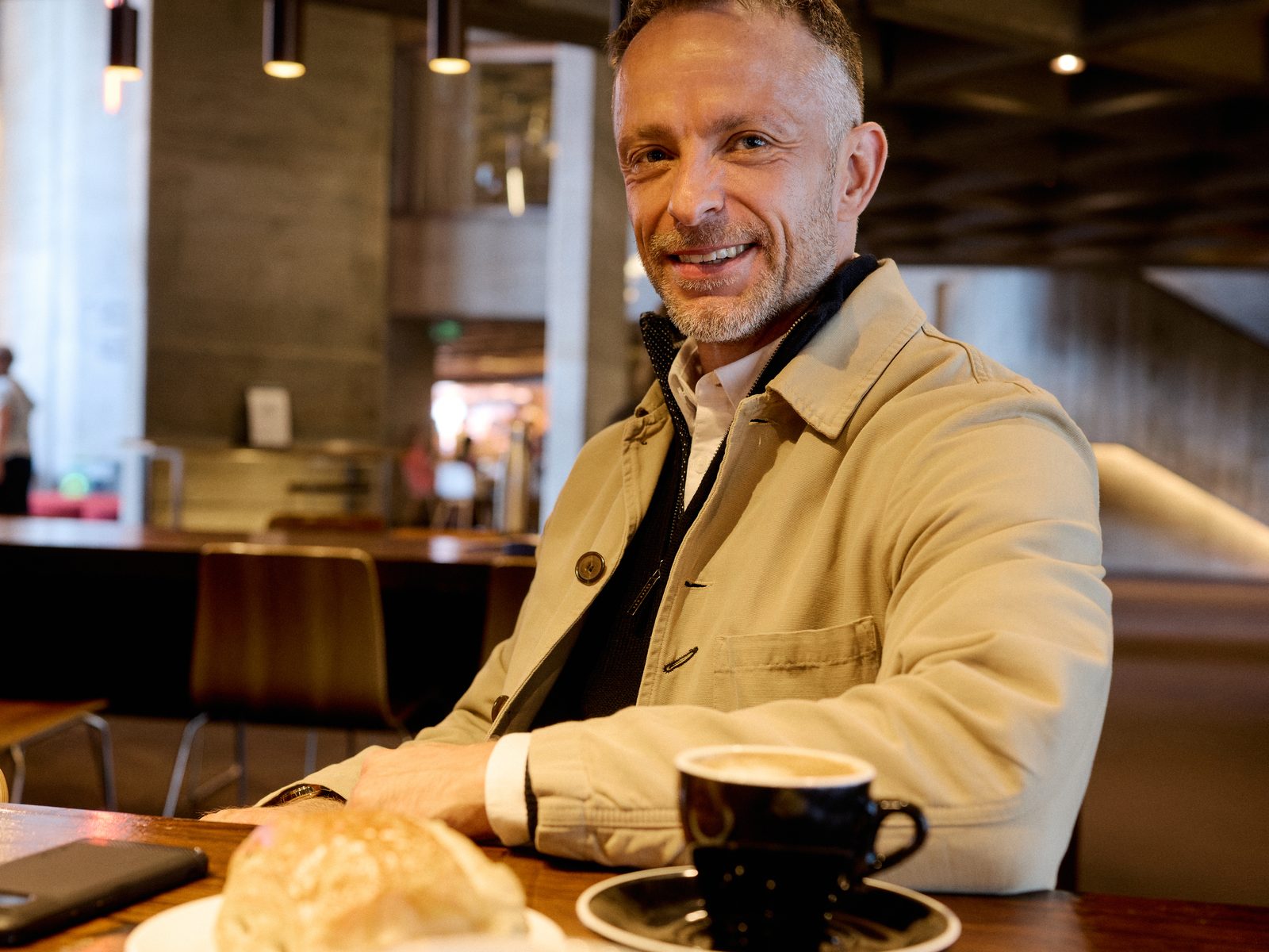Gavin Cooper at a café table with a coffee, Bristol, 2026